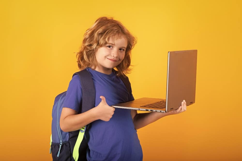 School child using laptop computer to access school resources.